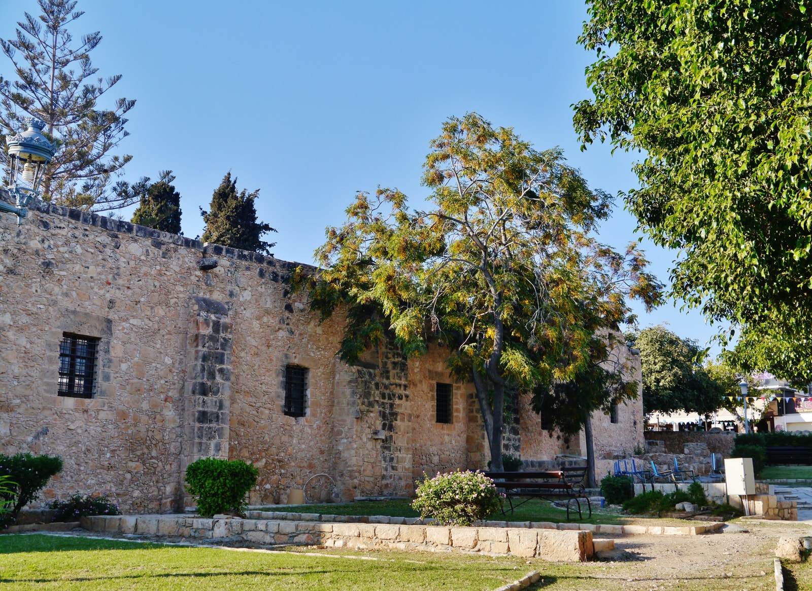 The medieval stone exterior wall of the Ayia Napa Monastery, a key cultural landmark in the town center.