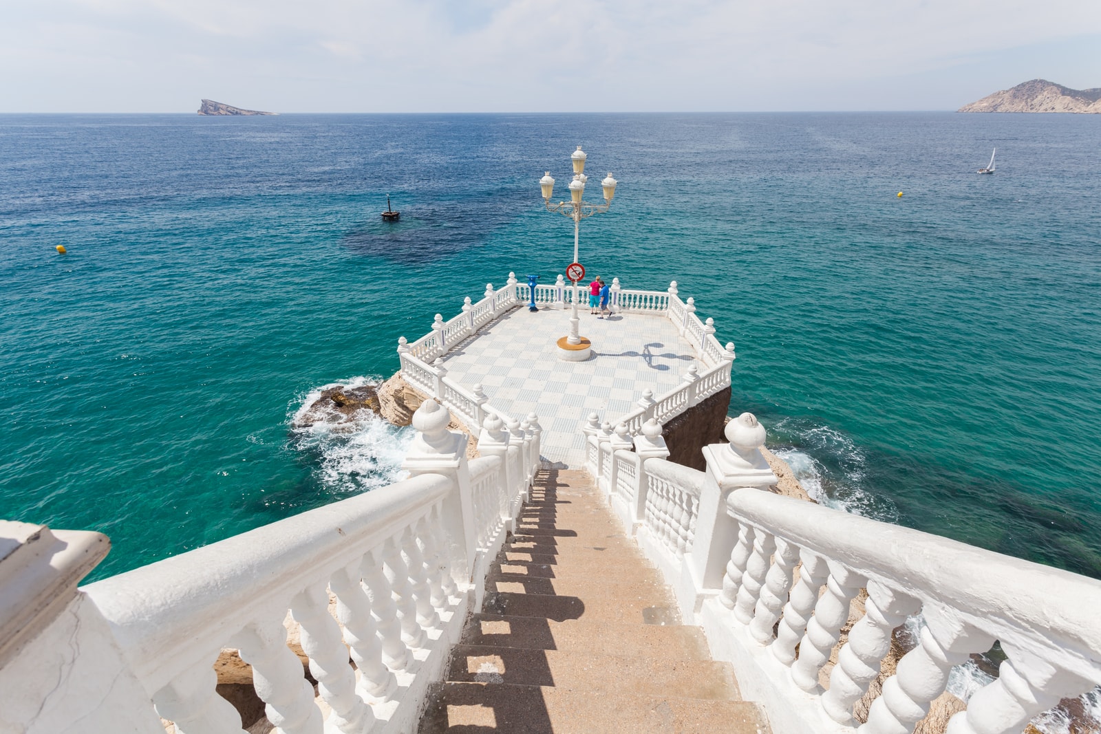 The checkered tile platform of the Balcón del Mediterráneo viewpoint, with a white balustrade overlooking the sea.