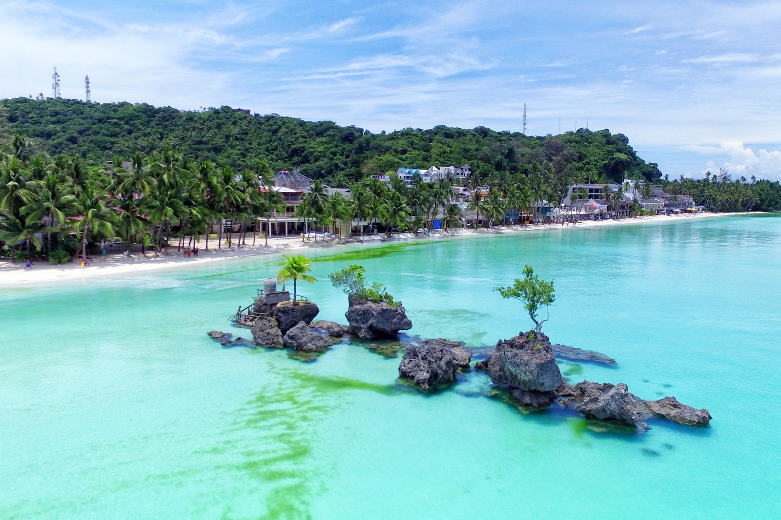 An elevated view of Willy's Rock, a prominent rock formation in the turquoise waters off the coast of Boracay.