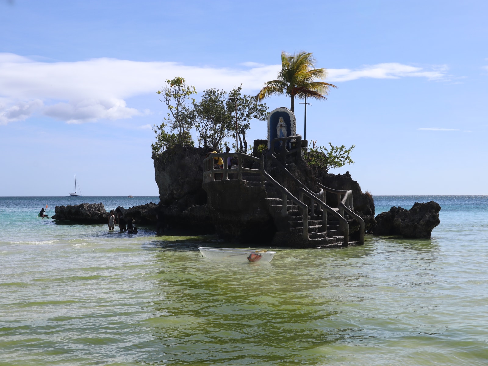 A frontal view of Willy's Rock, showing the grotto and stairs leading up to the statue.