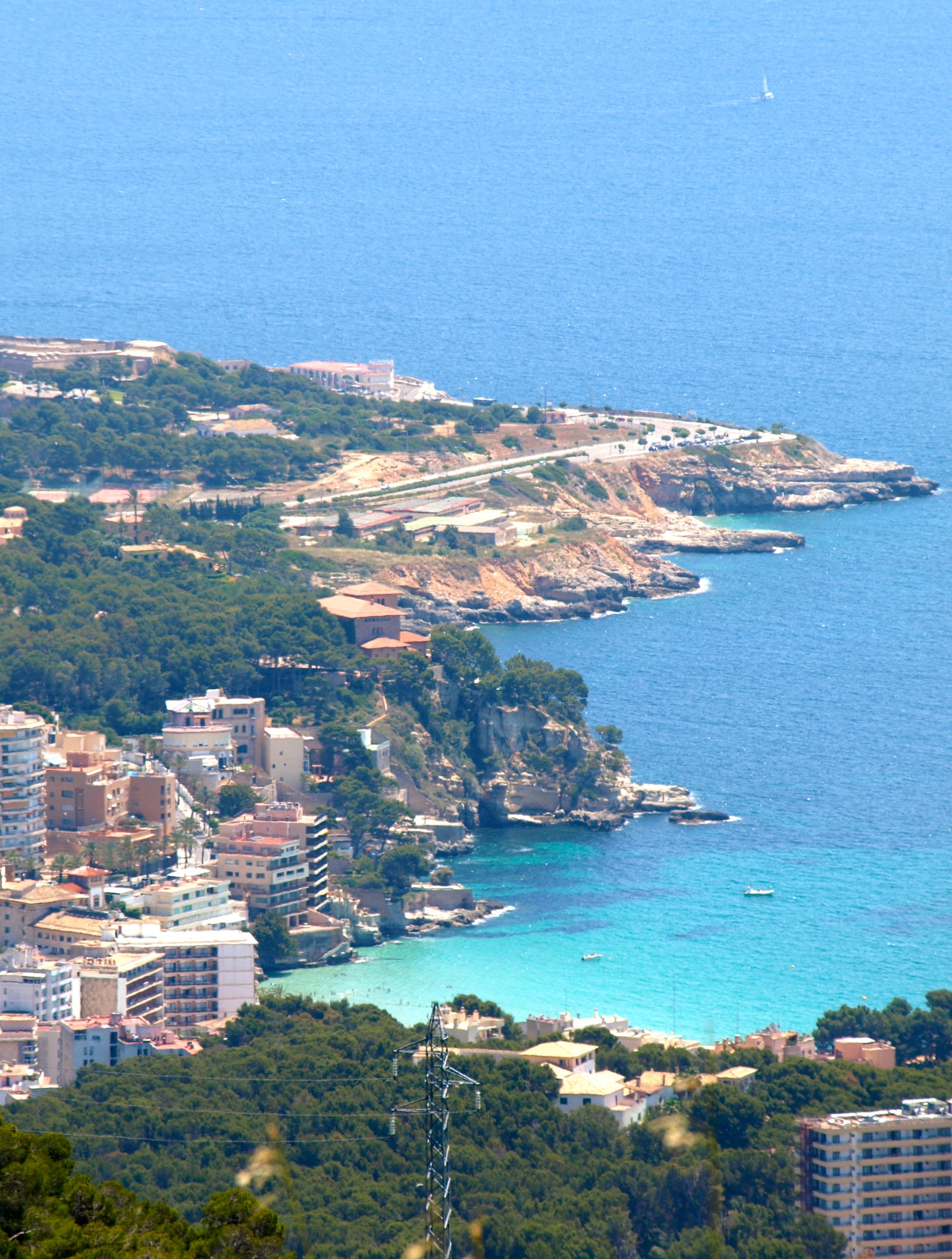 An elevated perspective of the coves of Cala Major and Caló des Grells, showing the rocky coast and resort development.