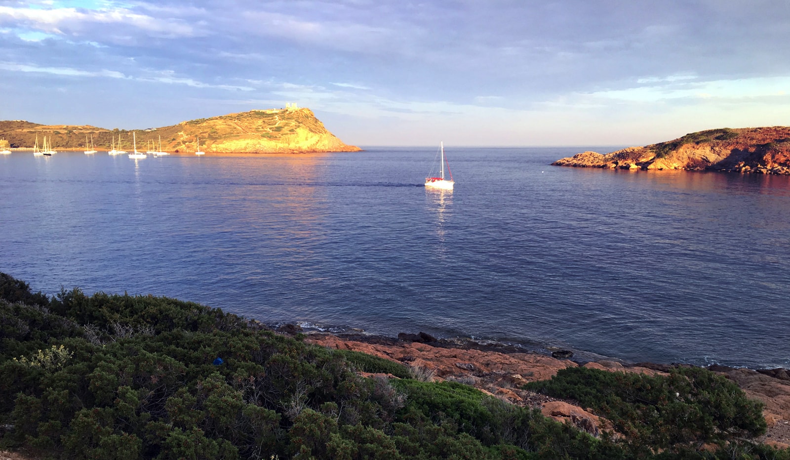 A panoramic view of the rugged coastline and bays around Cape Sounion.
