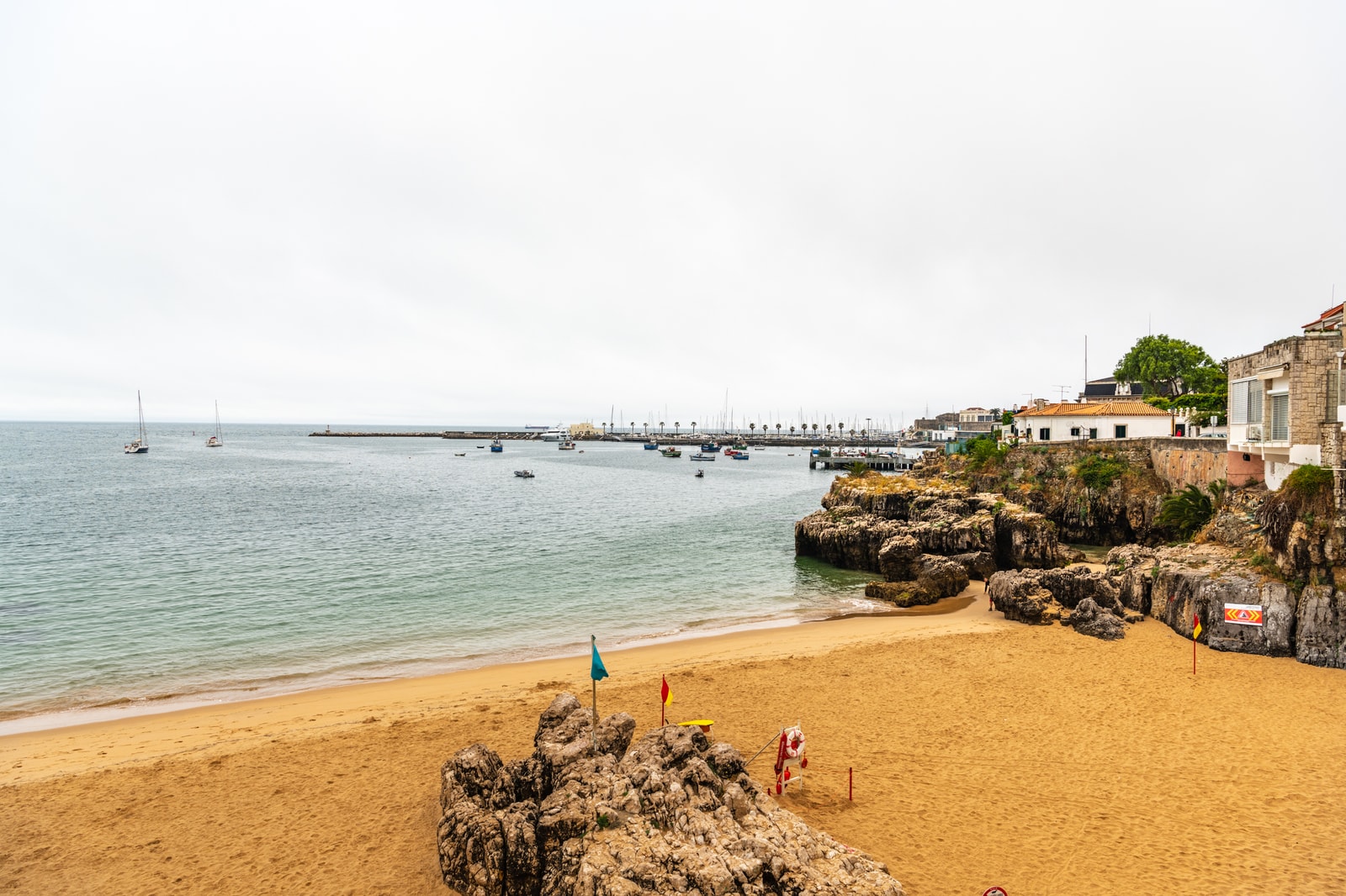 Close up of beach safety lifebuoy on the tranquil harbor waterfront of Cascais Bay