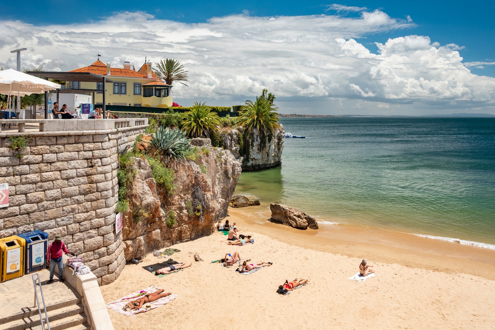 Overview of Queen's Beach (Praia da Rainha) in Cascais, showing the calm bay and historic beachfront chalet palace