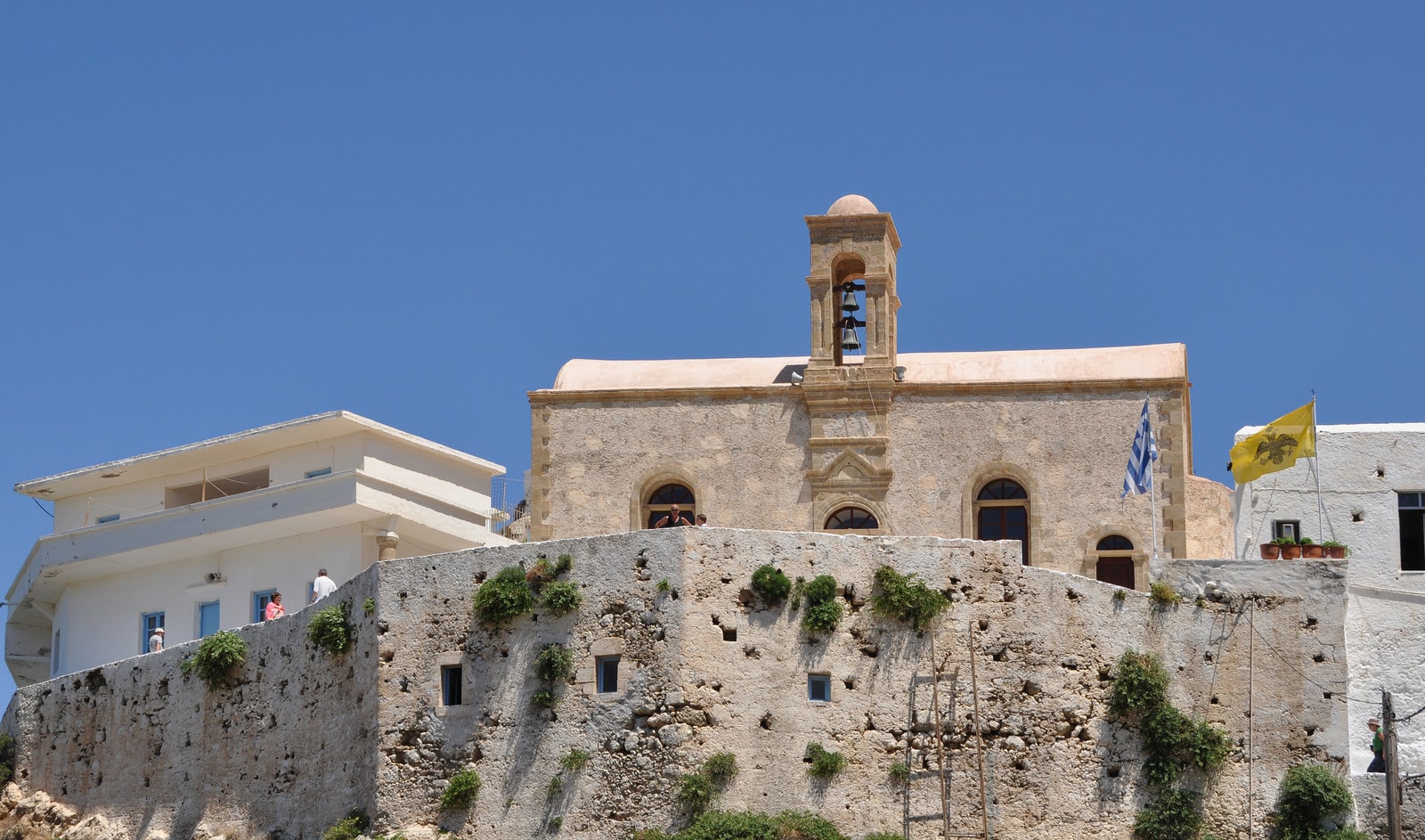 The historic Chrysoskalitissa Monastery perched atop a large rock formation overlooking the sea.