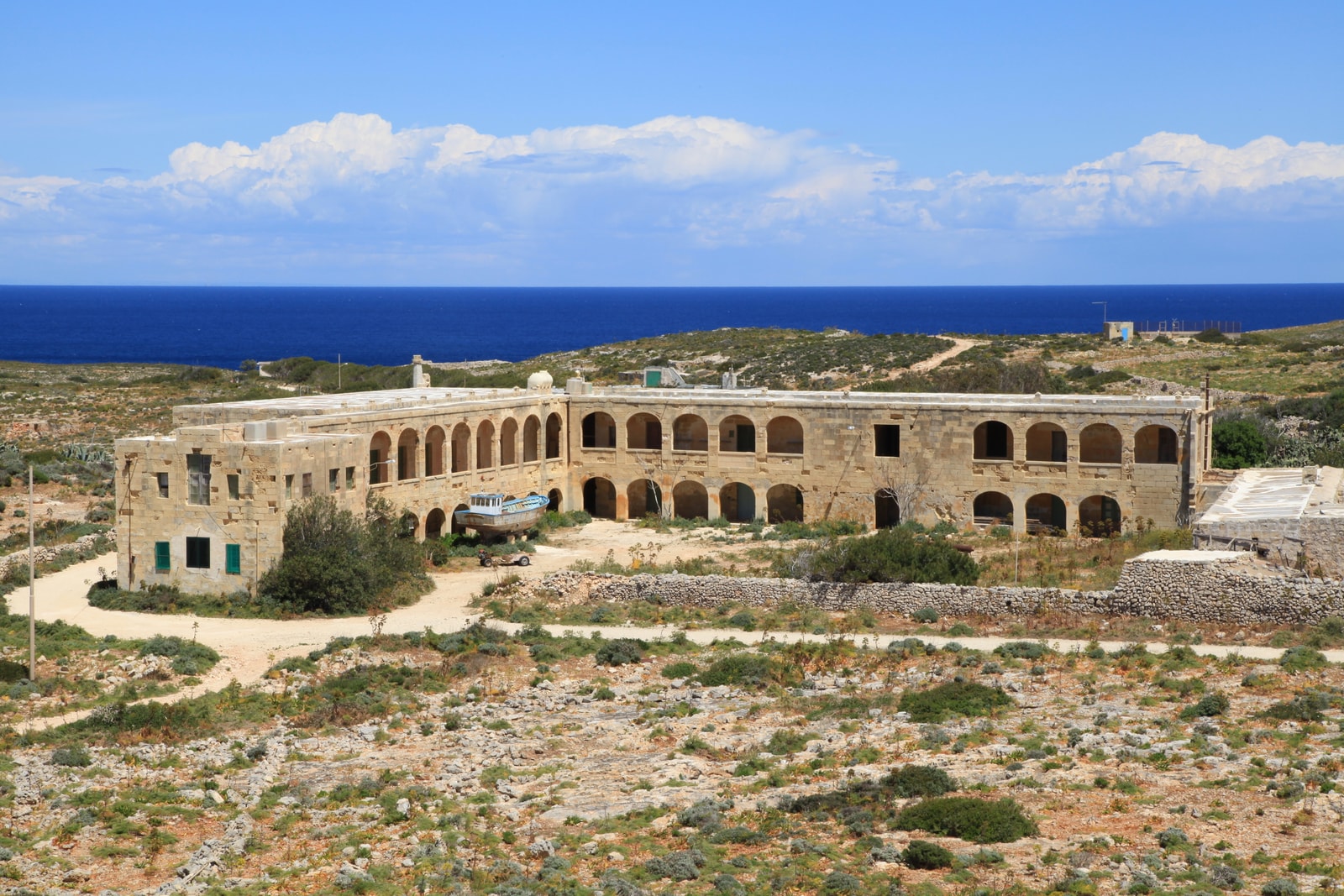 The abandoned British-era quarantine hospital on Comino, with its distinct stone arches.