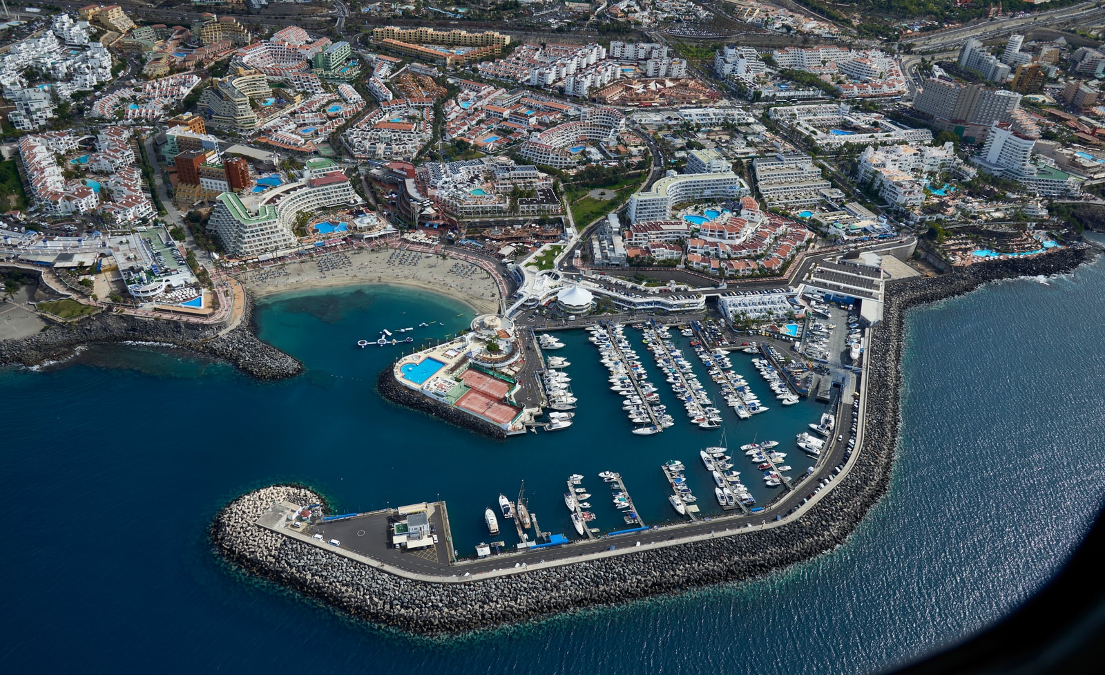 An aerial view of the harbor and resort development in Adeje, Tenerife.
