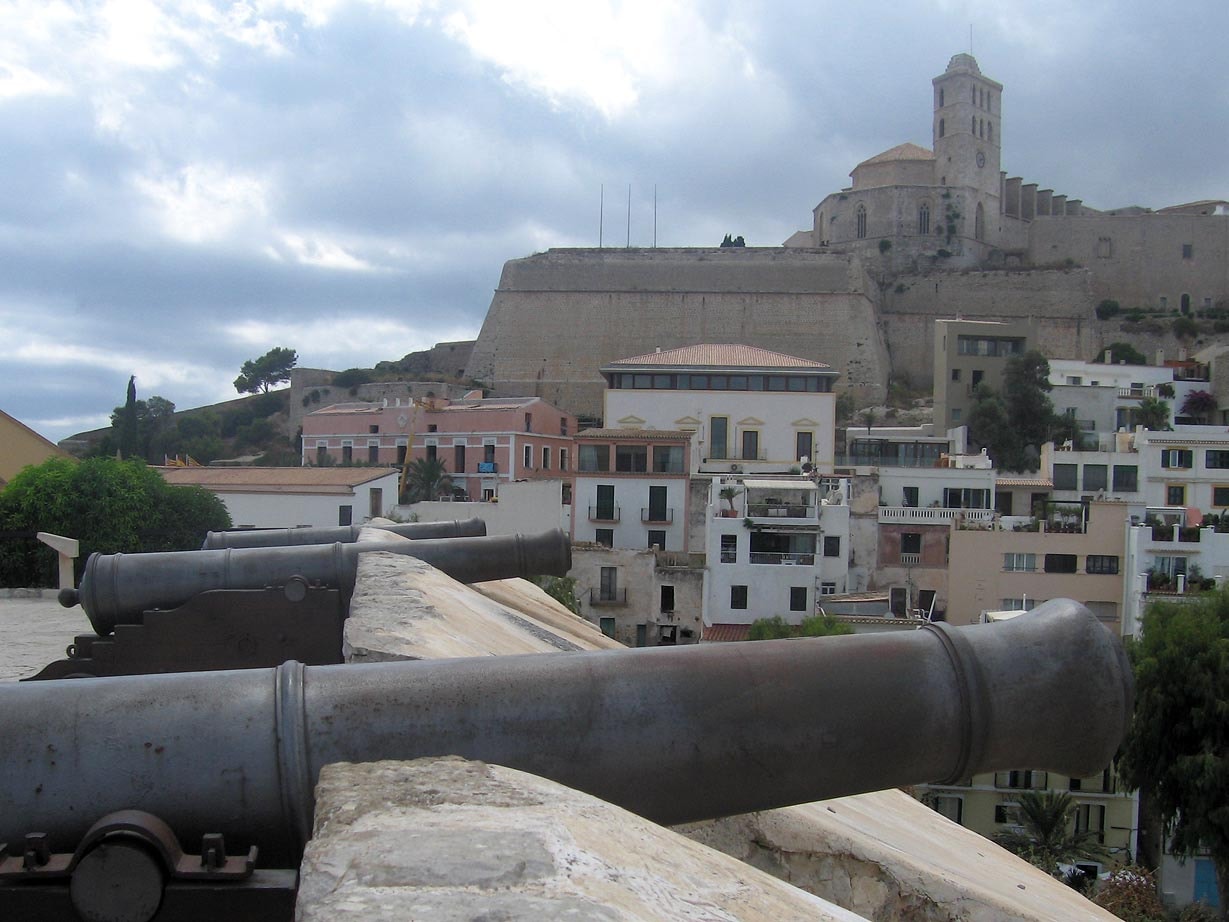 An old iron cannon on the ramparts of Dalt Vila, overlooking the town and harbor.
