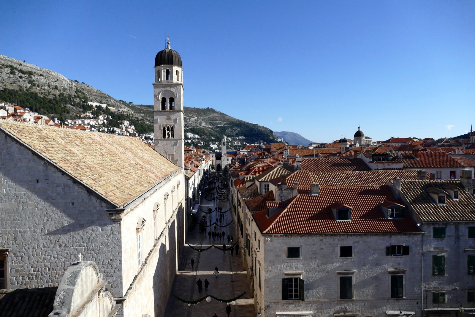A view from the city walls over the rooftops and a bell tower in Dubrovnik.