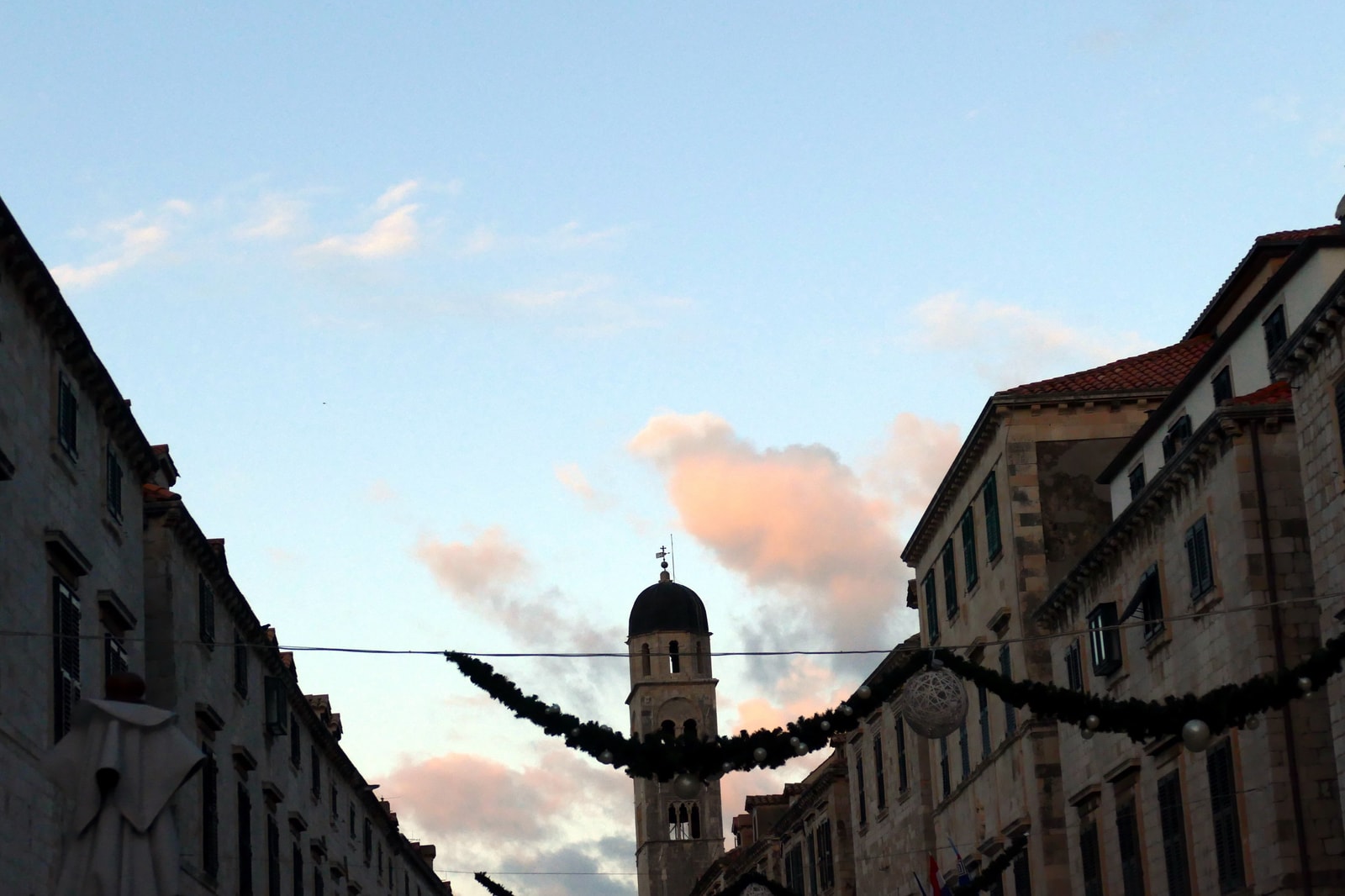 The Stradun in Dubrovnik at sunrise, decorated with holiday garlands.