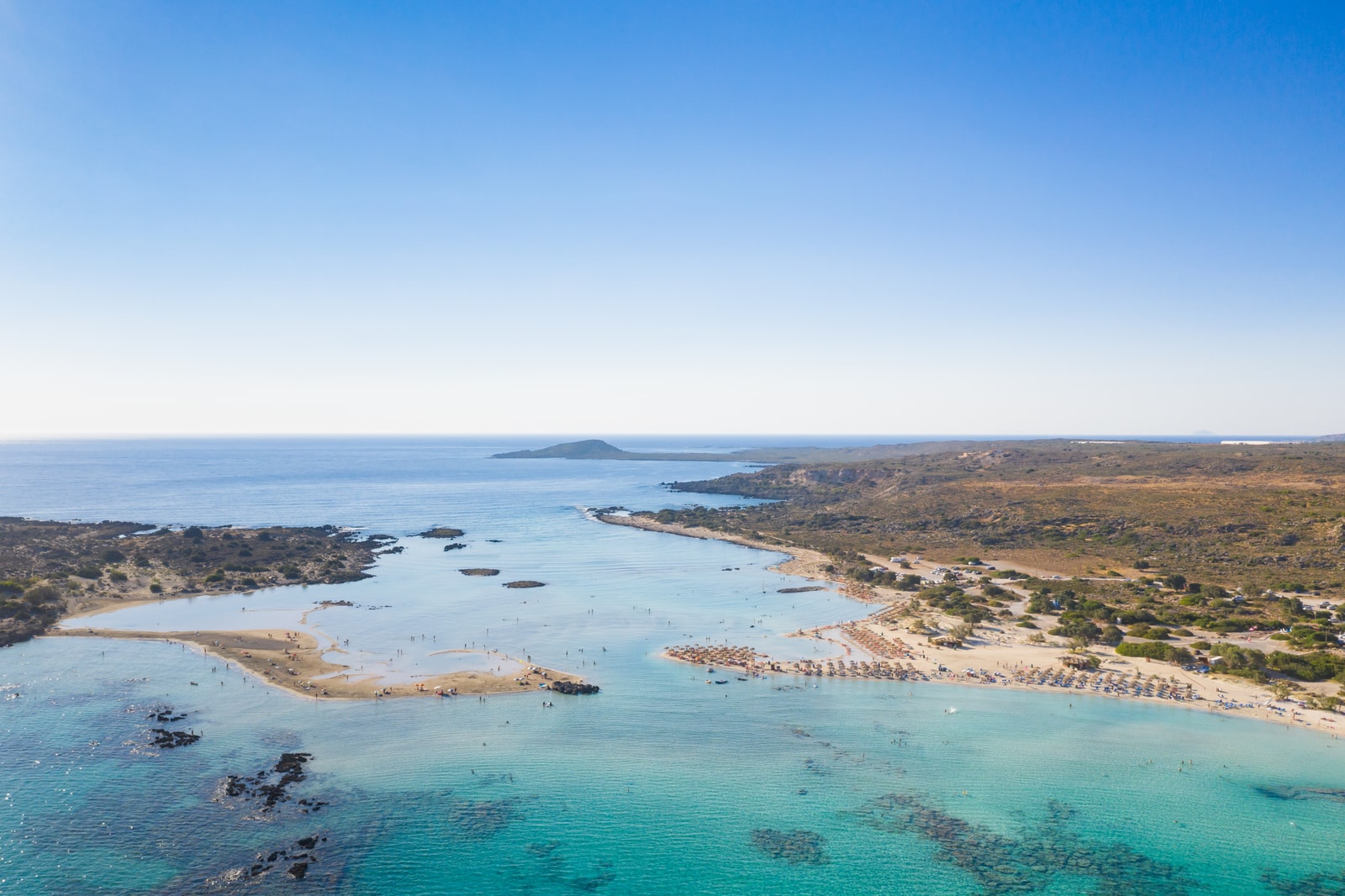A drone shot captures the sandbar that connects the mainland of Crete to the protected Elafonisi Island.