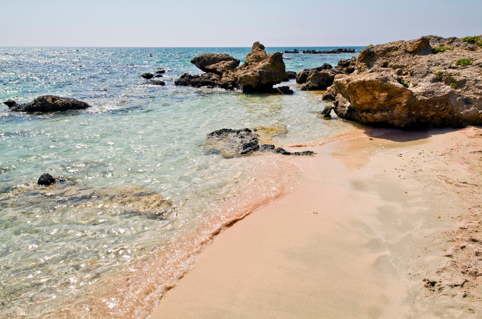 Close-up of the distinctive pink-hued sand at Elafonisi Beach.