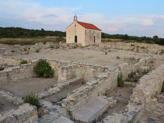 The archaeological site of Ivinj near Pirovac, showing ancient ruins and the historic Saint Martin’s Church.