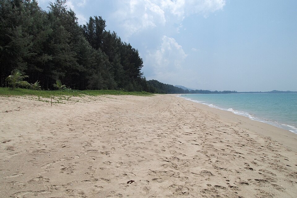 An empty stretch of sand within Khao Lak–Lam Ru National Park, showcasing the undeveloped and spacious feel of the coastline.