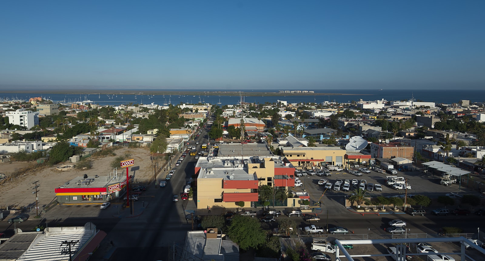 A high-resolution photo showing the city of La Paz spreading along the coast of a large bay.