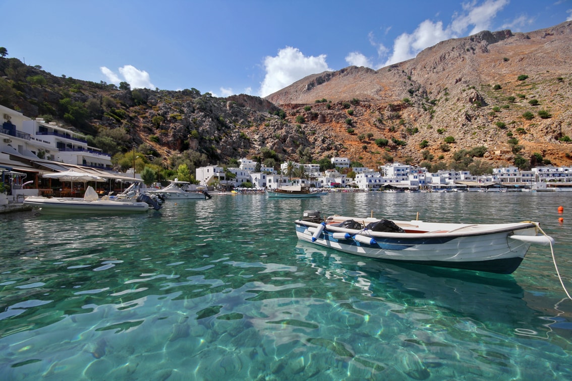The serene, car-free village of Loutro, with its whitewashed buildings, sits directly on the calm, clear waters of the Libyan Sea.
