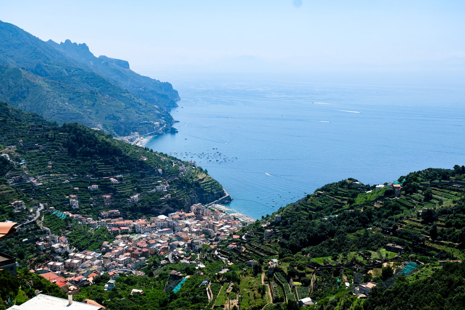 A high-resolution overview of Minori’s shore and the surrounding terraced hills.
