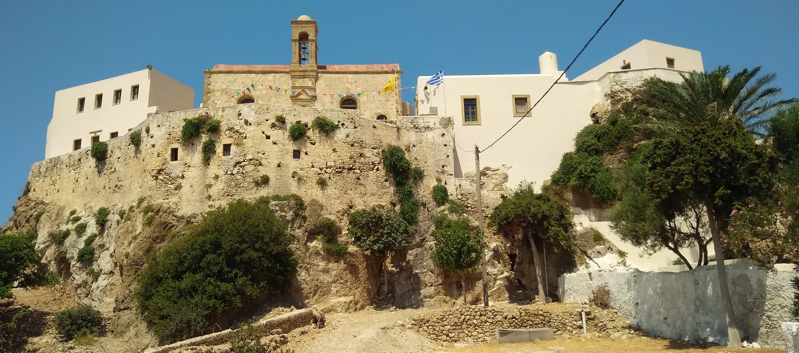 A wide view of the Moni Chrissoskalitissa monastery on its seaside rock.
