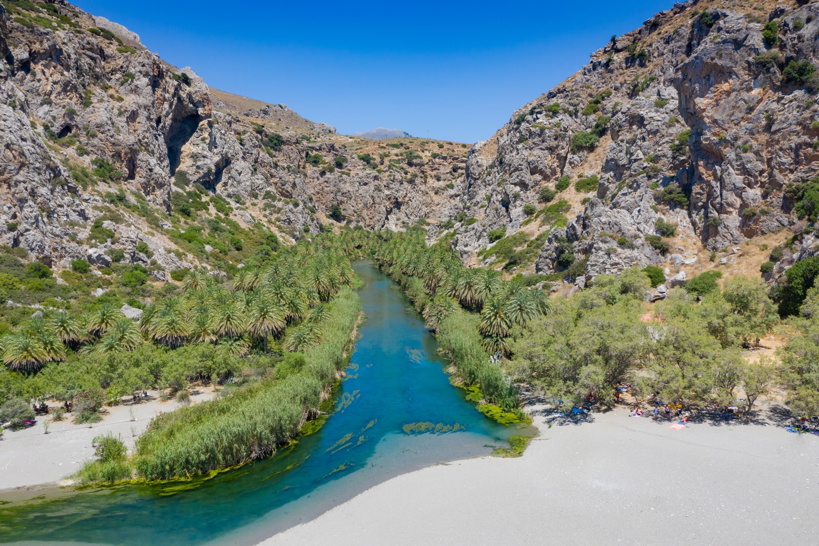 An aerial view showing the dense palms surrounding Preveli beach