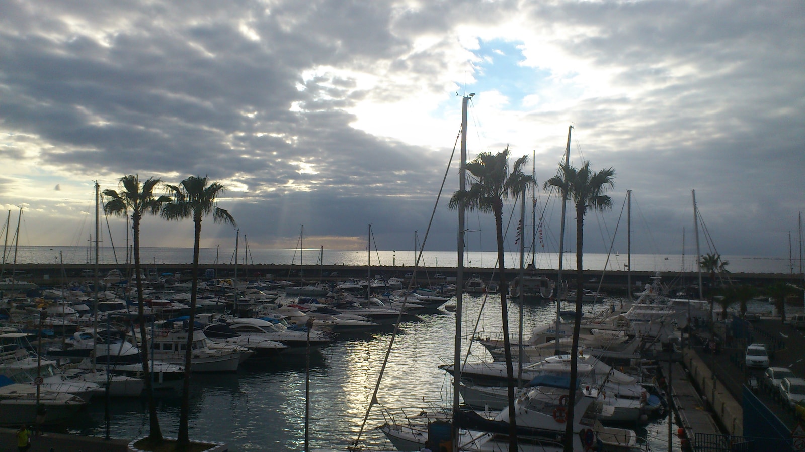 Boats in Puerto Colón marina on a sunny day with some clouds.