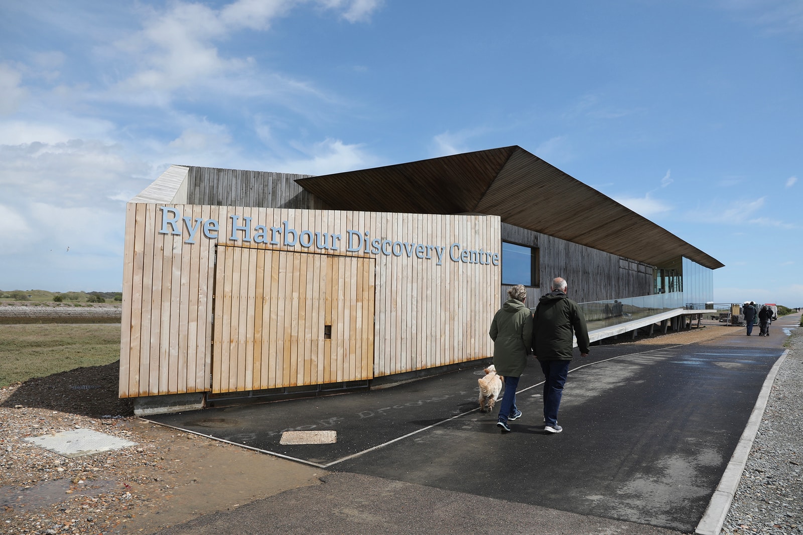 The modern wooden facade of the Rye Harbour Discovery Centre.