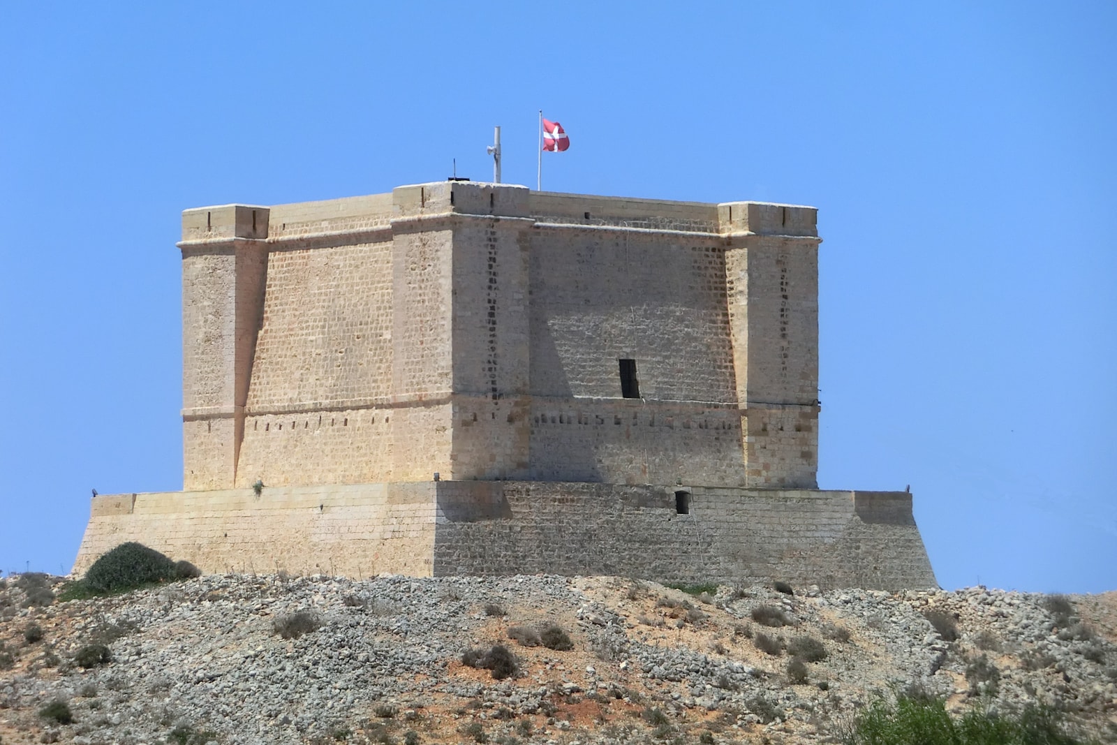A detailed, low-angle shot of the stone walls of Santa Marija Tower.