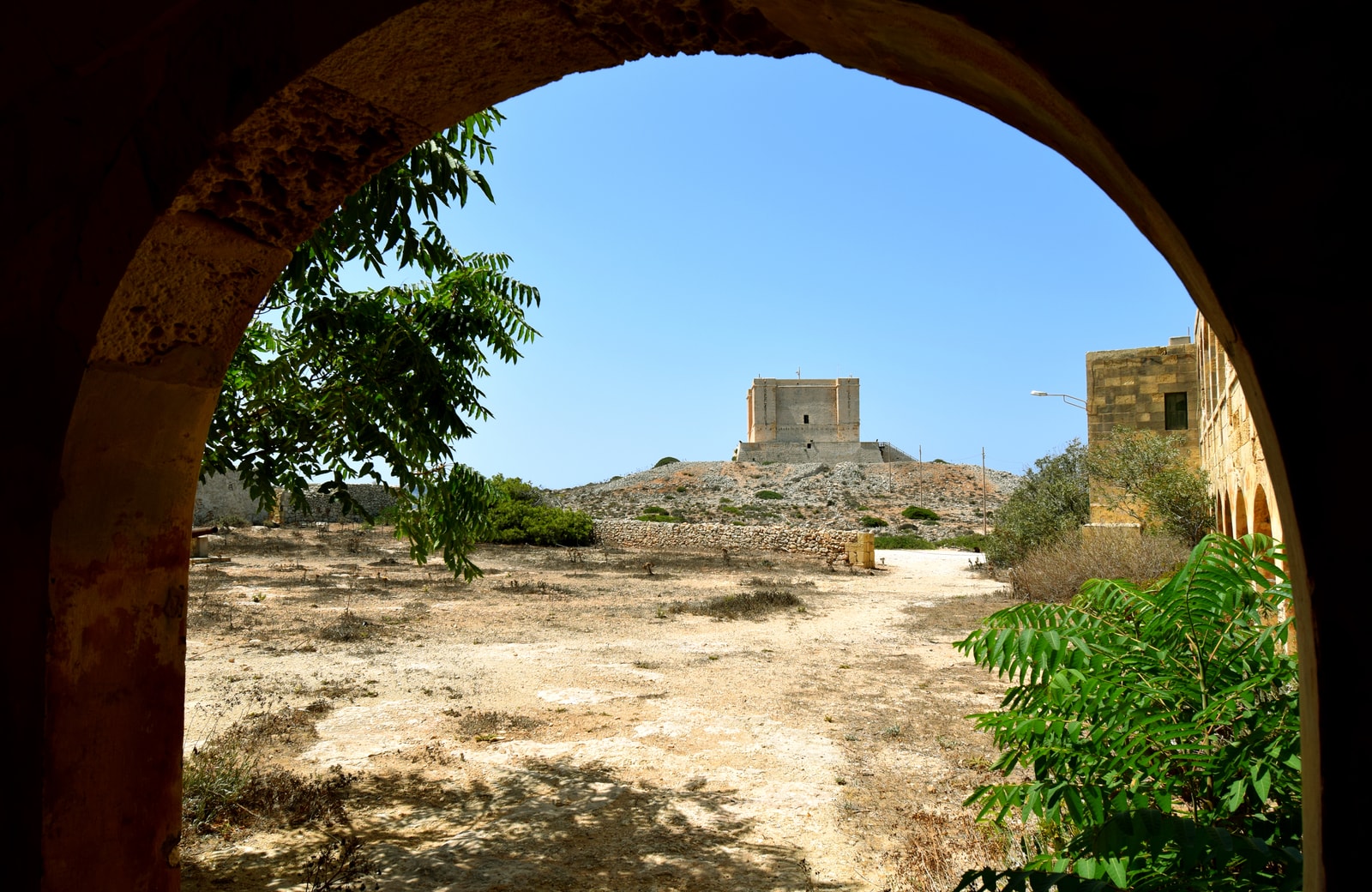 St. Mary's Tower viewed through a stone arch of the abandoned British hospital.