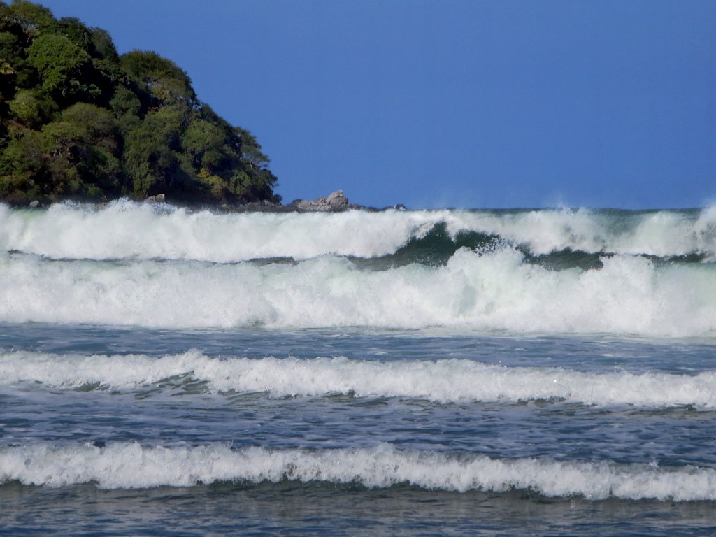 Powerful waves break along the shore in Sayulita, hinting at the town's strong surf culture.