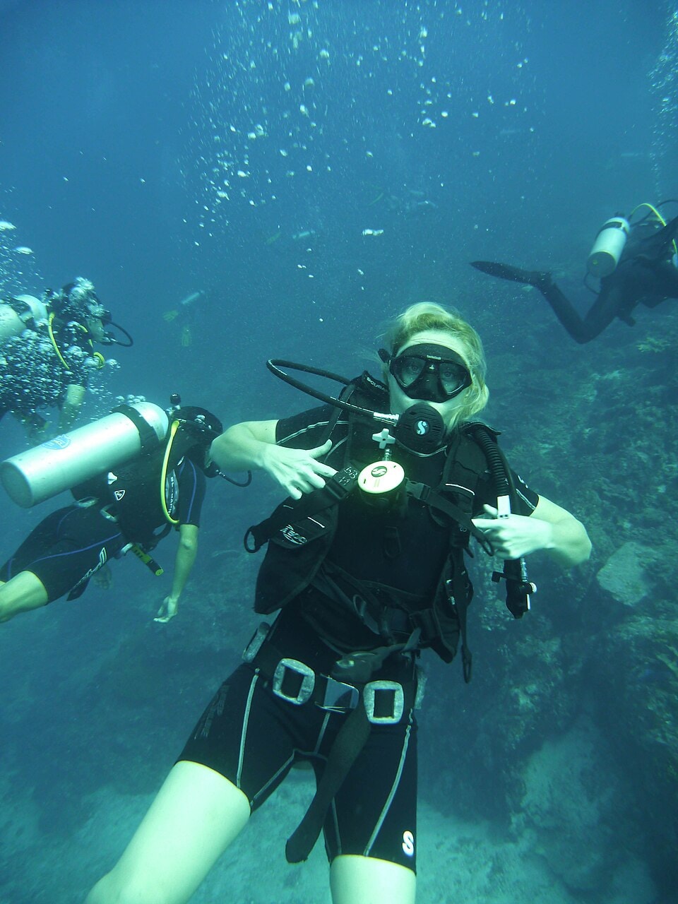 A group of scuba divers explores the underwater world of the Similan Islands.