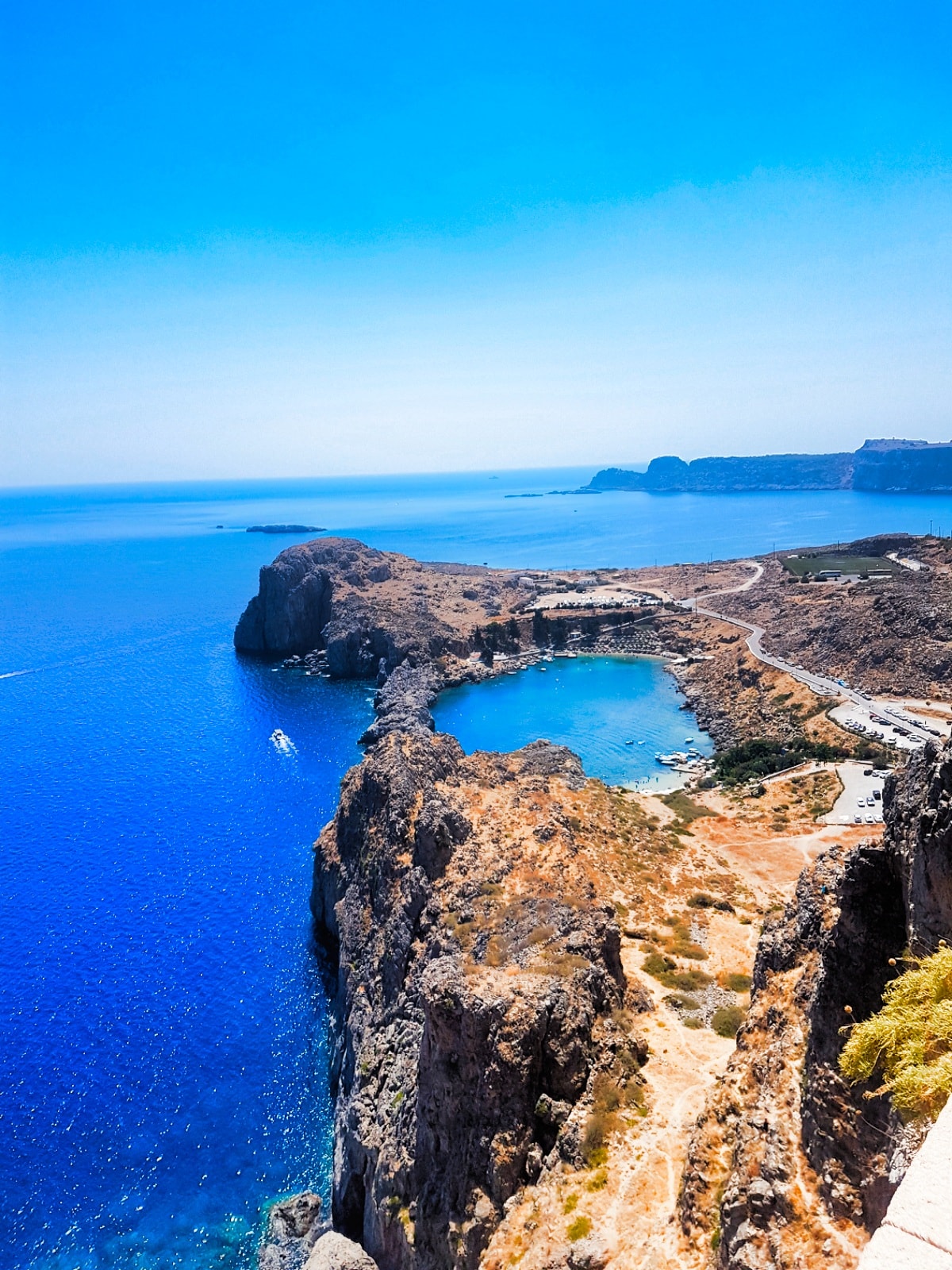A high-angle view of the enclosed St. Paul's Bay, showing its vibrant turquoise water and rocky shoreline.