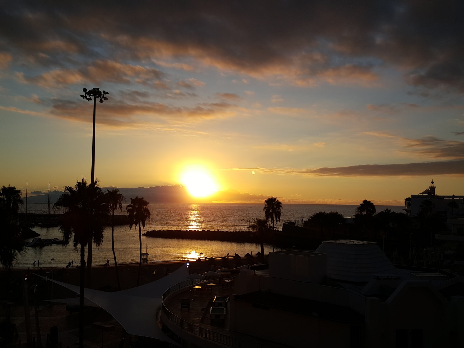 Silhouettes of boats in Puerto Colón marina during a colourful sunset.