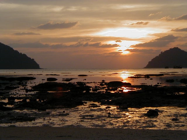An atmospheric shoreline sunset at Surin Island National Park.