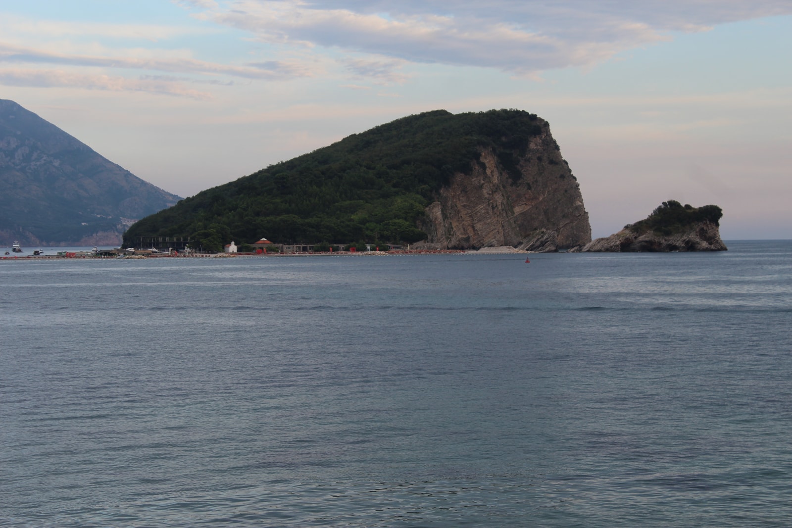 The wild, uninhabited side of Sveti Nikola island shows its dramatic vertical limestone cliffs plunging directly into the Adriatic Sea.