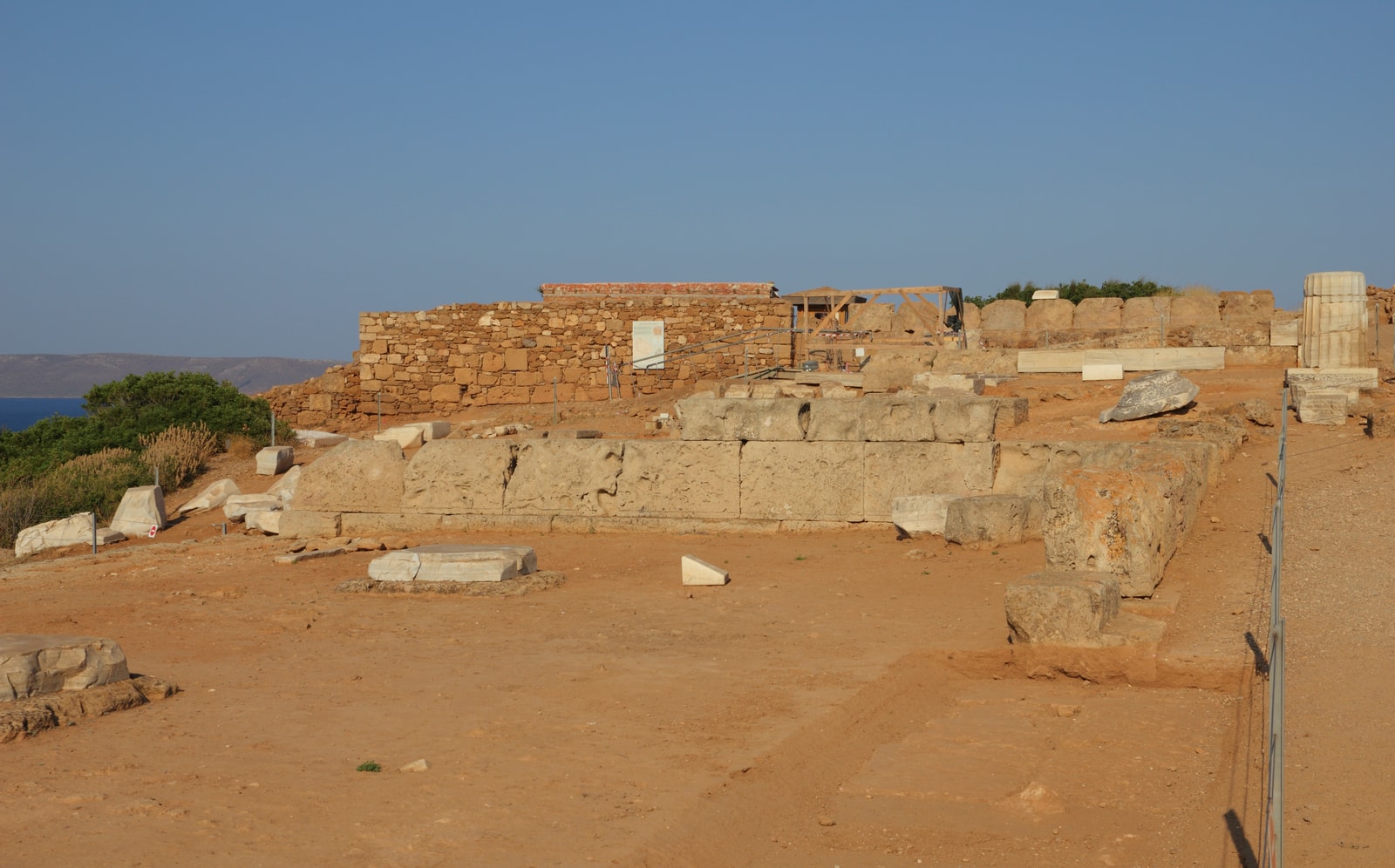 A close-up view of the ruins and stone blocks at the Temple of Poseidon archaeological site.