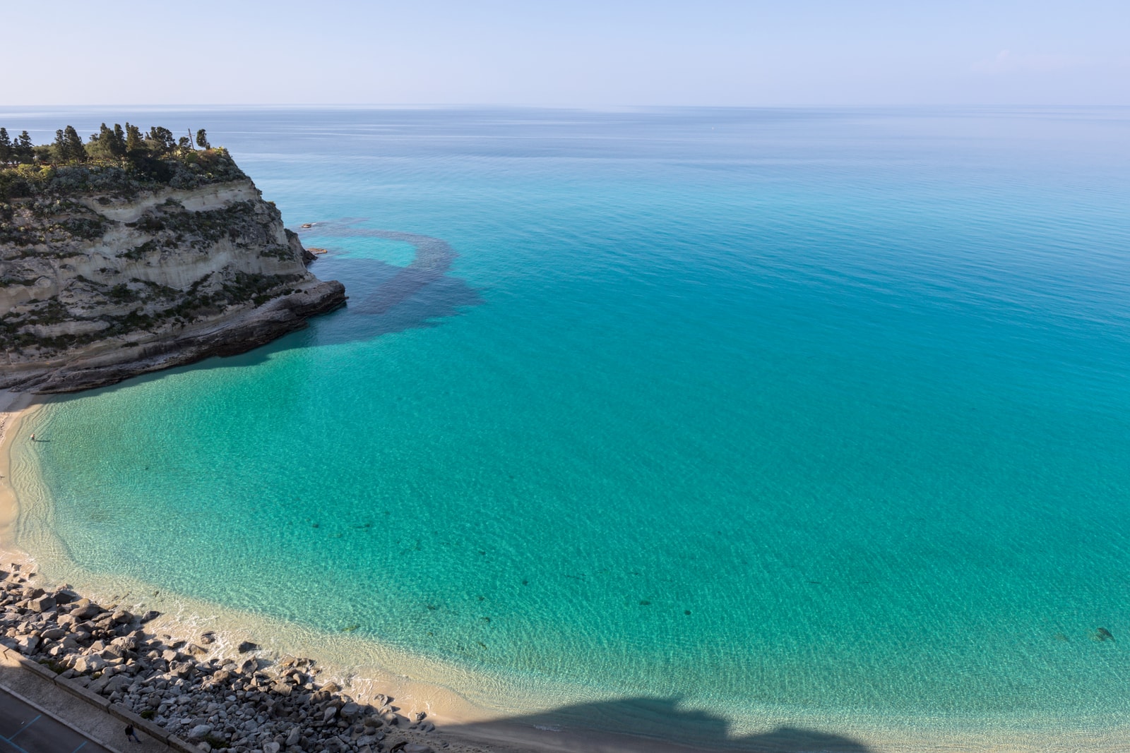 An overlook from Tropea's cliffs shows the stunningly clear and luminous turquoise sea below.